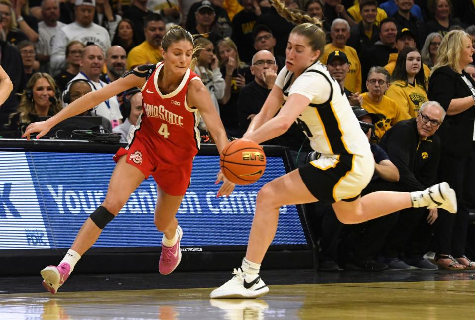 Ohio State guard Jacy Sheldon (4) and Iowa guard Kate Martin, right, chase the ball during the first half of an NCAA college basketball game, Sunday, March 3, 2024, in Iowa City, Iowa. (AP Photo/Cliff Jette)