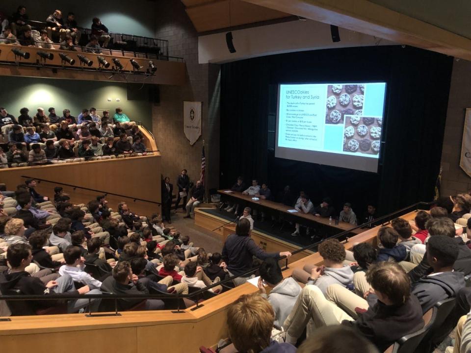 At a recent school assembly at Christ School, Fletcher eighth grader Elliott Stay does his presentation about a bake sale he's doing for earthquake victims in Turkey and Syria.