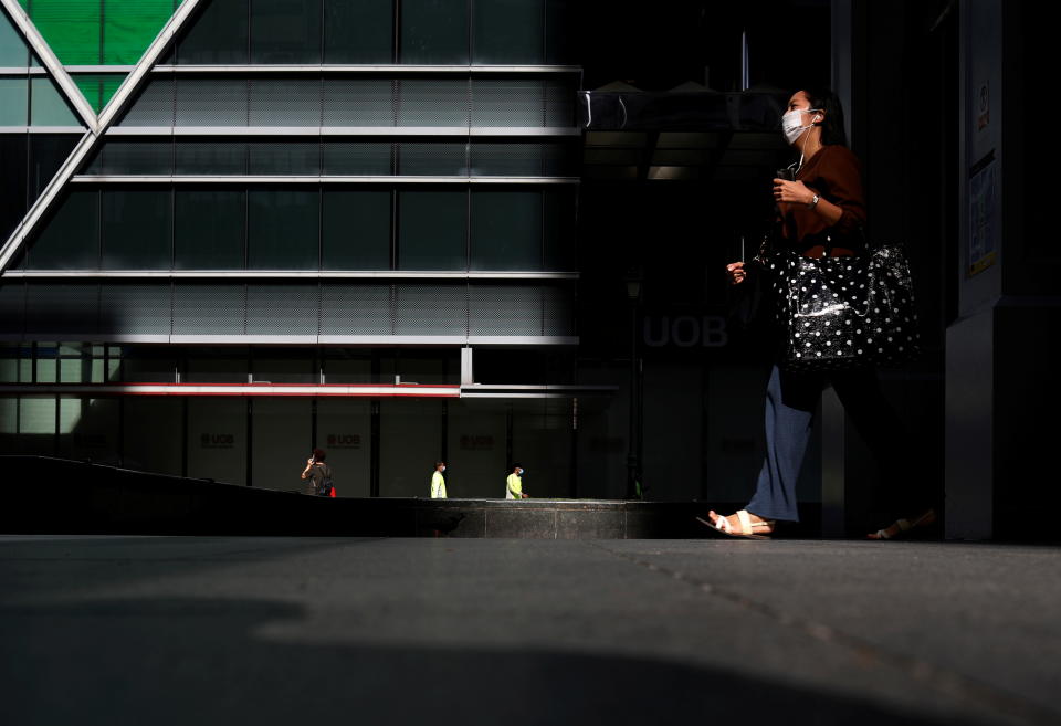 Office workers are seen at a largely empty central business district as Singapore returns to the work-from-home regime due to surging cases in the coronavirus disease (COVID-19) outbreak, in Singapore September 27, 2021. REUTERS/Edgar Su