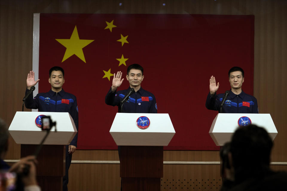 Chinese astronauts for the upcoming Shenzhou-18 mission, from left, Li Guangsu, Ye Guangfu and Li Cong wave as they arrive for a meeting with the press at the Jiuquan Satellite Launch Center in northwest China, Wednesday, April 24, 2024. (AP Photo/Andy Wong)