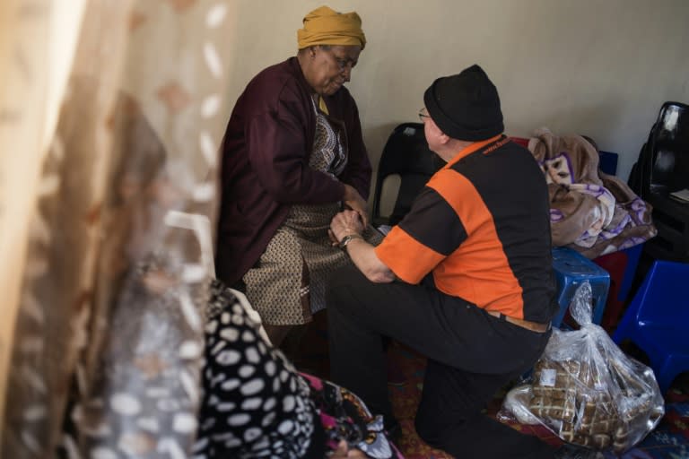 Adriaan Vlok, a born-again Christian, comforts Angelina Mamaleki after news that her son had passed away in Olievenhoutbosch township in Centurion