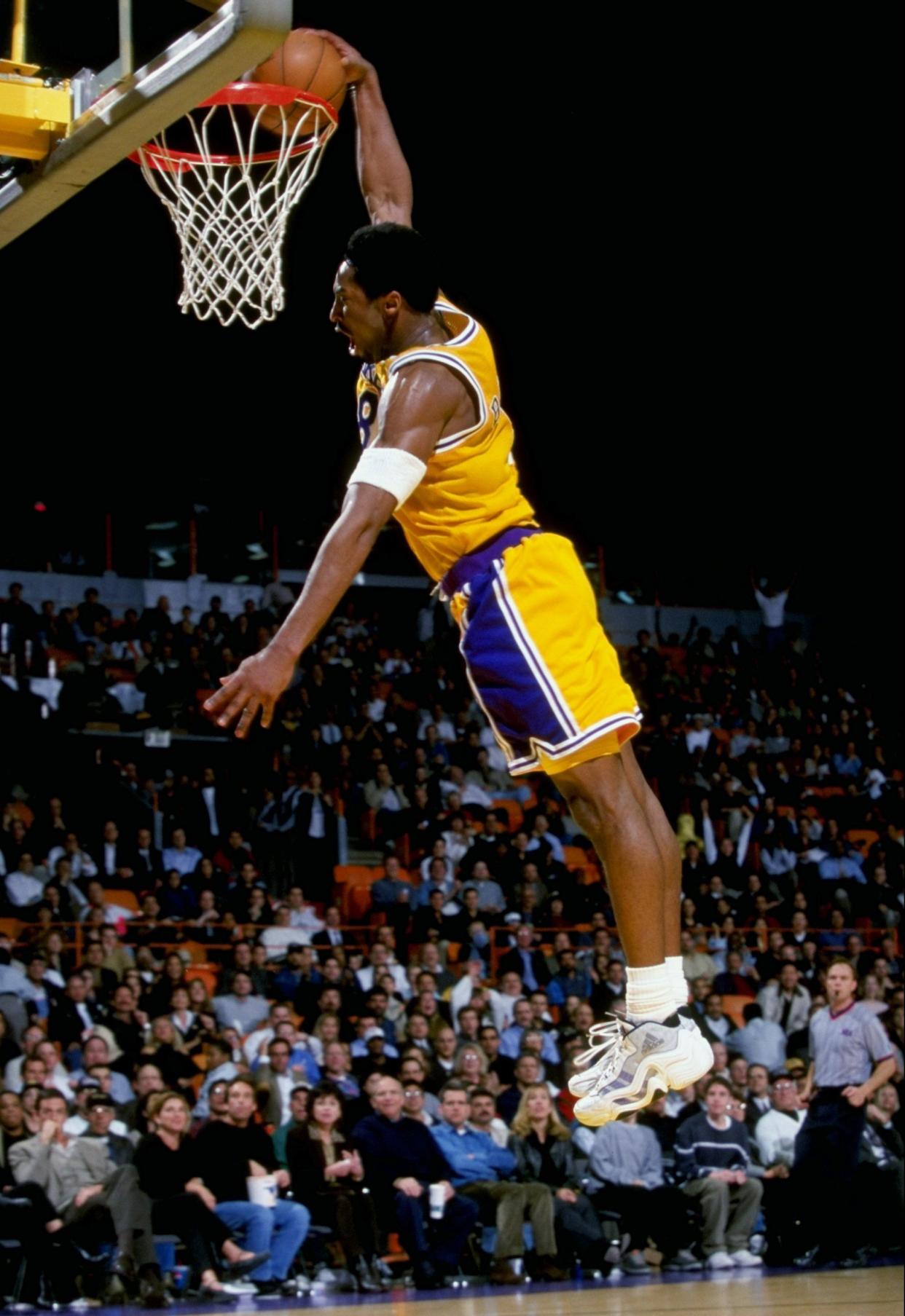 Guard Kobe Bryant #8 of the Los Angeles Lakers makes a slam dunk during the game against the Charlotte Hornets at the Great Western Forum in Inglewood, Calif. on Feb. 16, 1999. The Lakers defeated the Hornets 116-88.