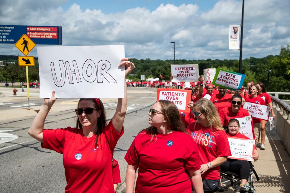 Nurses and their supporters march around hospital buildings during a University of Michigan Professional Nurse Council informational picket at Fuller Park in Ann Arbor on July 16, 2022.