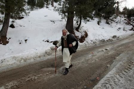 A man walks down the road from the ski resort in Malam Jabba, Pakistan February 7, 2017. REUTERS/Caren Firouz/Files