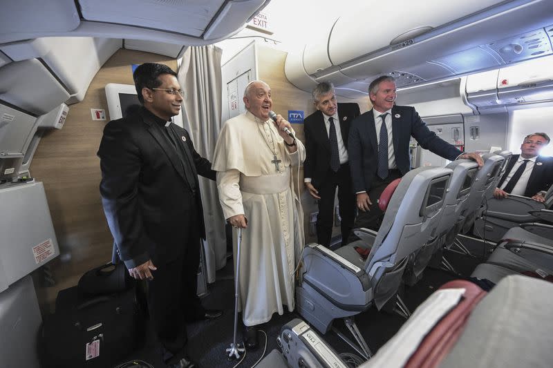 Pope Francis attends a press conference aboard the papal plane returning from Mongolia