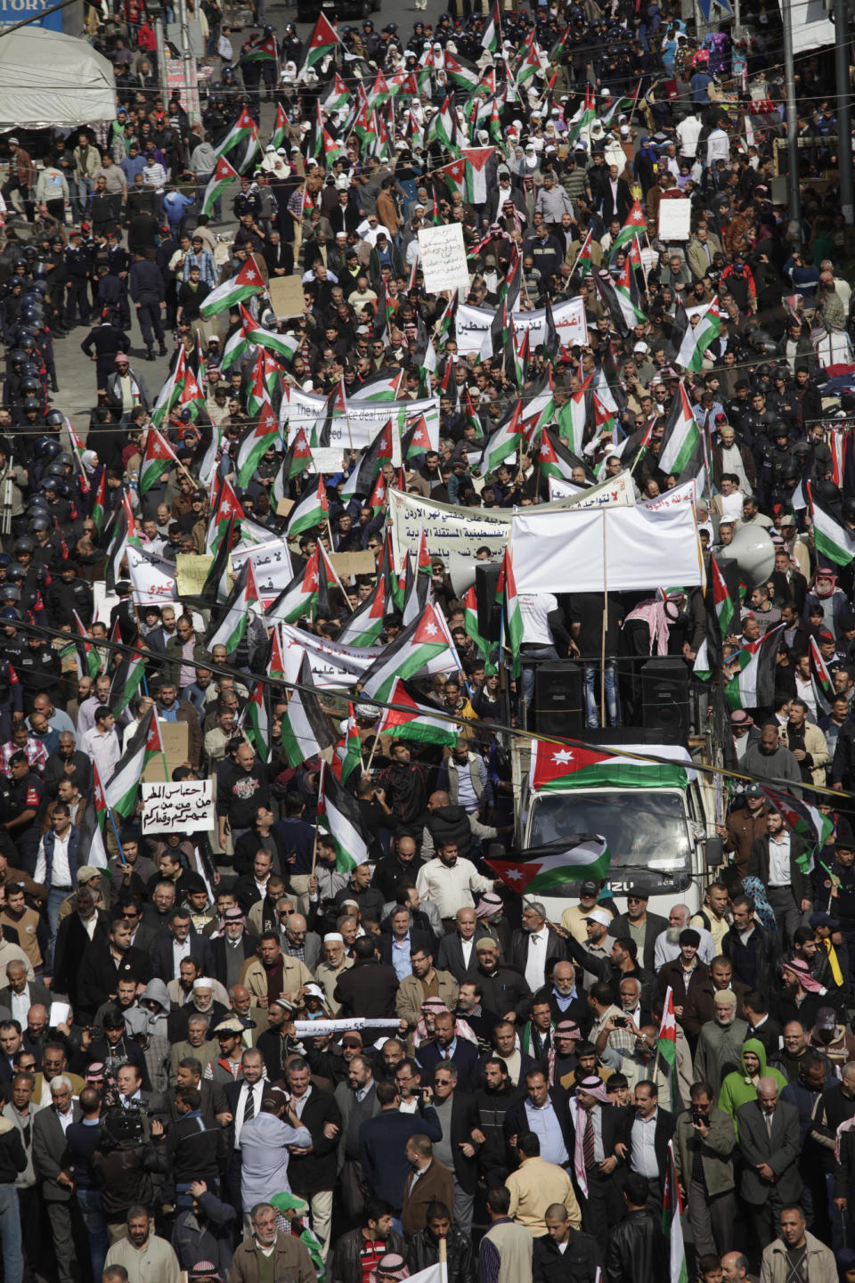 Thousands of protesters affiliated with Jordan's Muslim Brotherhood against U.S. Secretary of State John Kerry's peace talks hold a rally in downtown Amman, Jordan, Friday, Feb. 14, 2014. Hours before Jordan's King Abdullah II met with U.S. President Barack Obama in California, his Islamist opposition at home has staged its largest protest in several months to reject a peaceful Mideast settlement. (AP Photo/Mohammad Hannon)