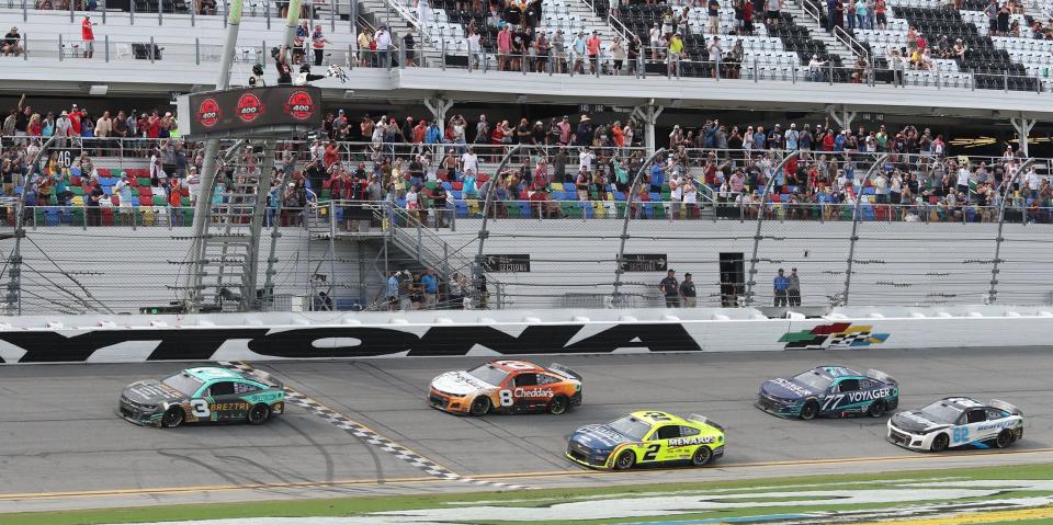 Austin Dillon takes the checkered flag on Sunday to win the rain-delayed Coke Zero Sugar 400 at Daytona International Speedway.