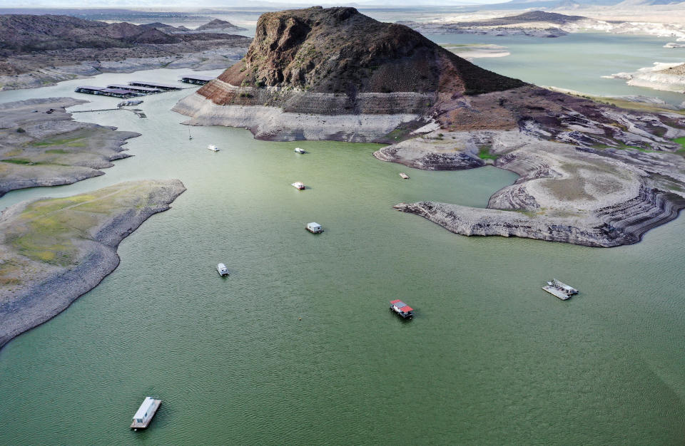 TRUTH OR CONSEQUENCES, NEW MEXICO - AUGUST 16: An aerial view of boats anchored near a 'bathtub ring' of mineral deposits left by higher water levels at the drought-stricken Elephant Butte Reservoir on August 16, 2022 near Truth or Consequences, New Mexico. New Mexico’s largest reservoir is currently at 3.8 percent of its total capacity in spite of recent monsoon rains in the state. Experts say that despite monsoon rains delivering temporary relief to parts of the Southwest, the climate change-fueled megadrought remains entrenched in the West. U.S. President Joe Biden signed the $737 billion Inflation Reduction Act today which focuses on climate change, lower health care costs and creating clean energy jobs. (Photo by Mario Tama/Getty Images)