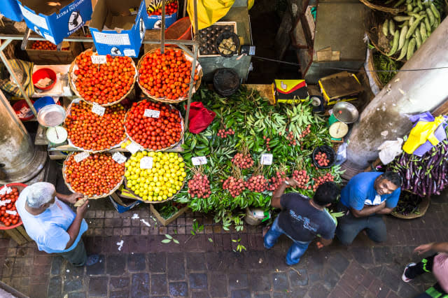 People shops for fresh fruits and vegetables in the traditional fresh market of Port Louis