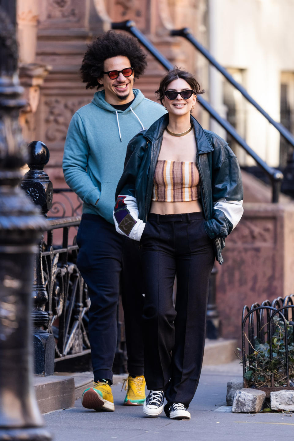 Eric and Emily smiling and walking down the street