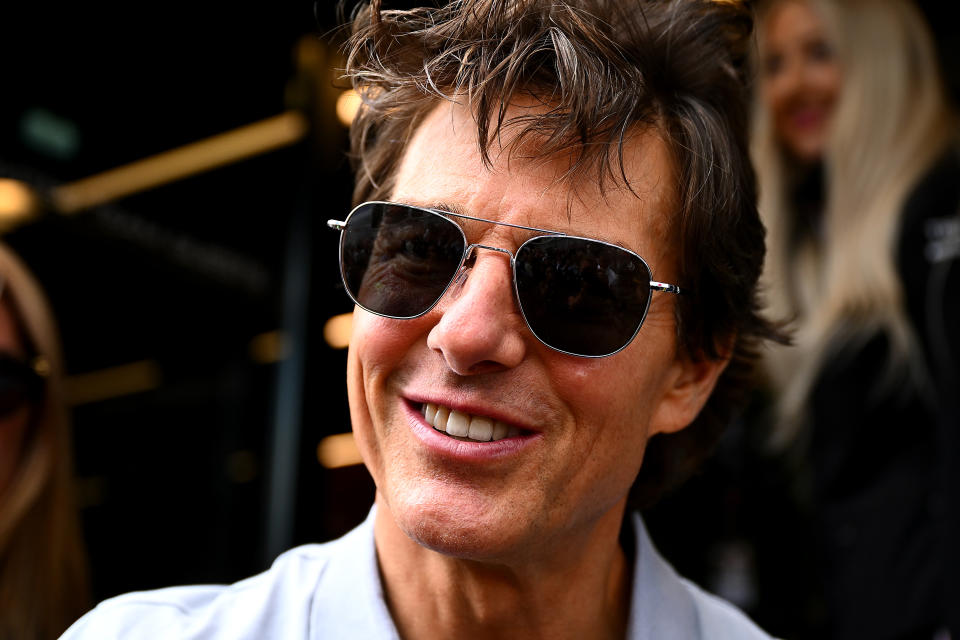 NORTHAMPTON, ENGLAND - JULY 03: Actor Tom Cruise walks in the Paddock prior to the F1 Grand Prix of Great Britain at Silverstone on July 03, 2022 in Northampton, England. (Photo by Clive Mason/Getty Images)