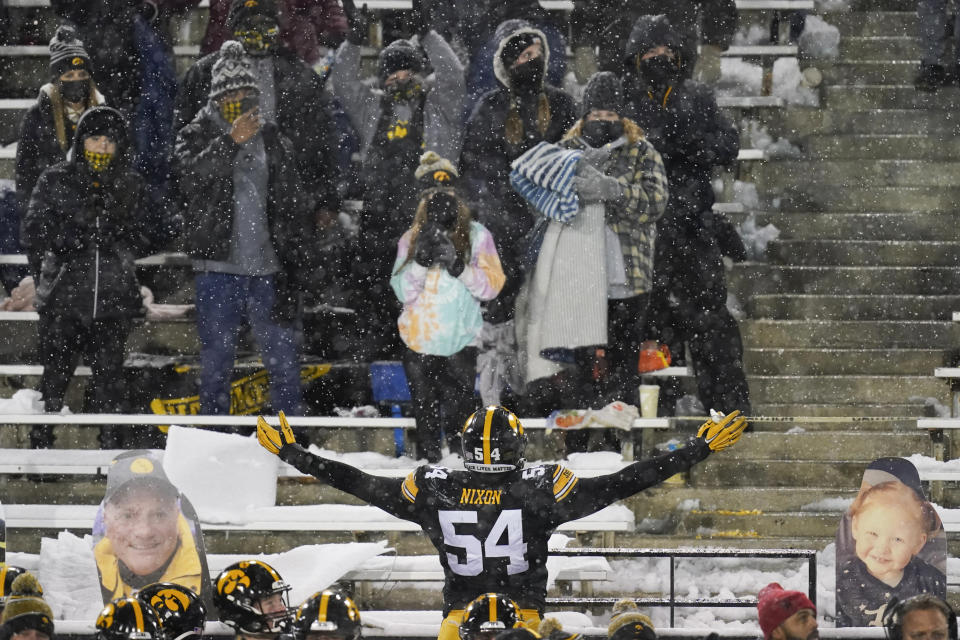 Iowa defensive tackle Daviyon Nixon (54) celebrates with fans in the stands at the end of an NCAA college football game against Wisconsin, Saturday, Dec. 12, 2020, in Iowa City, Iowa. Iowa won 28-7. (AP Photo/Charlie Neibergall)