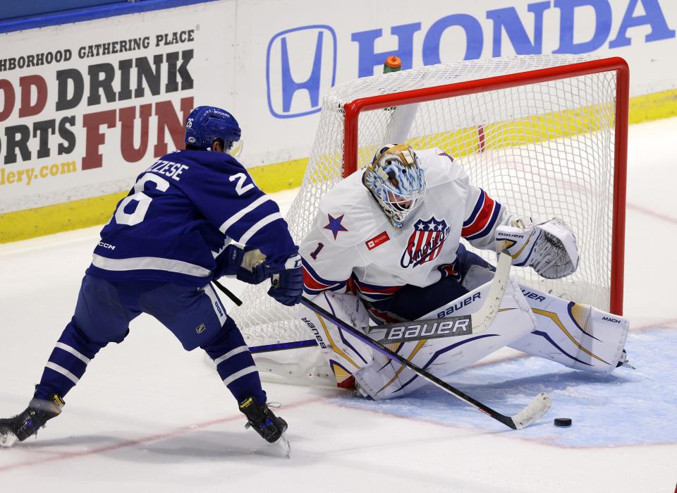 Toronto's Nick Abruzzese silice the puck in front of Amerks goalie Ukko-Pekka Luukkonen.