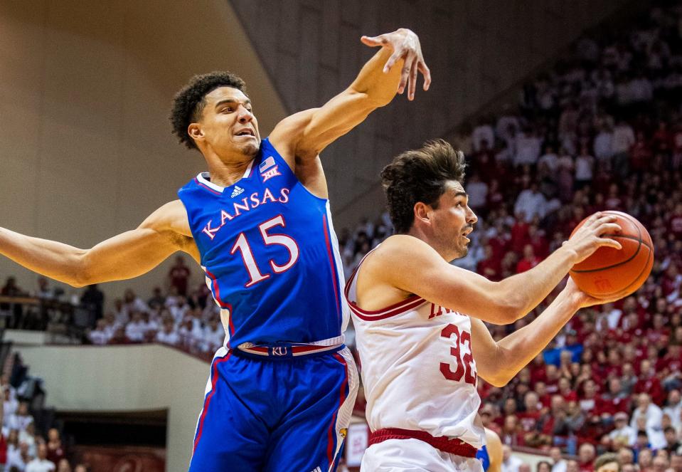 Indiana's Trey Galloway (32) looks to make a move against Kansas' Kevin McCullar Jr. (15) during the first half of a college basketball game at Simon Skjodt Assembly Hall on Dec. 16, 2023.