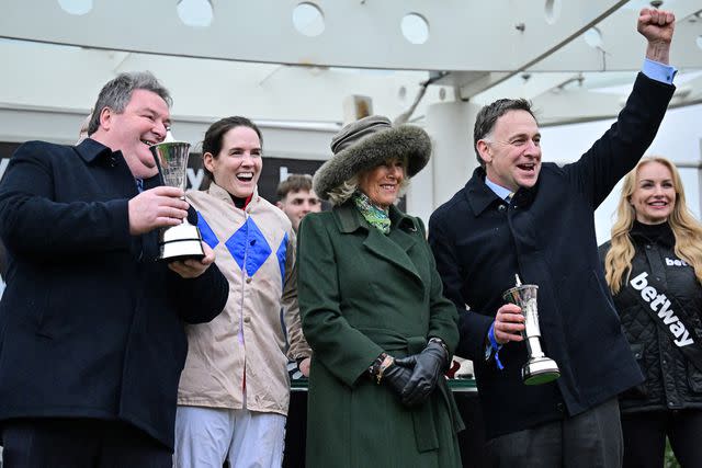 <p>BEN STANSALL/AFP via Getty </p> Queen Camilla hands out an award at the Cheltenham Festival on March 13, 2024