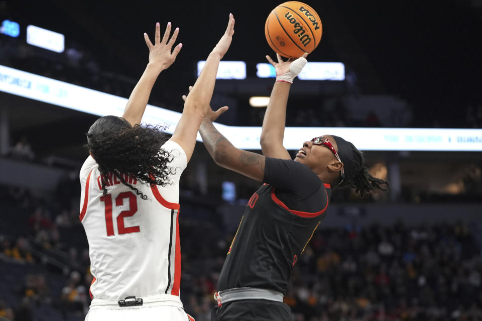 Maryland guard Shyanne Sellers shoots over Ohio State guard Celeste Taylor (12) during the first half of an NCAA college basketball game in the quarterfinals of the Big Ten women's tournament Friday, March 8, 2024, in Minneapolis. (AP Photo/Abbie Parr)