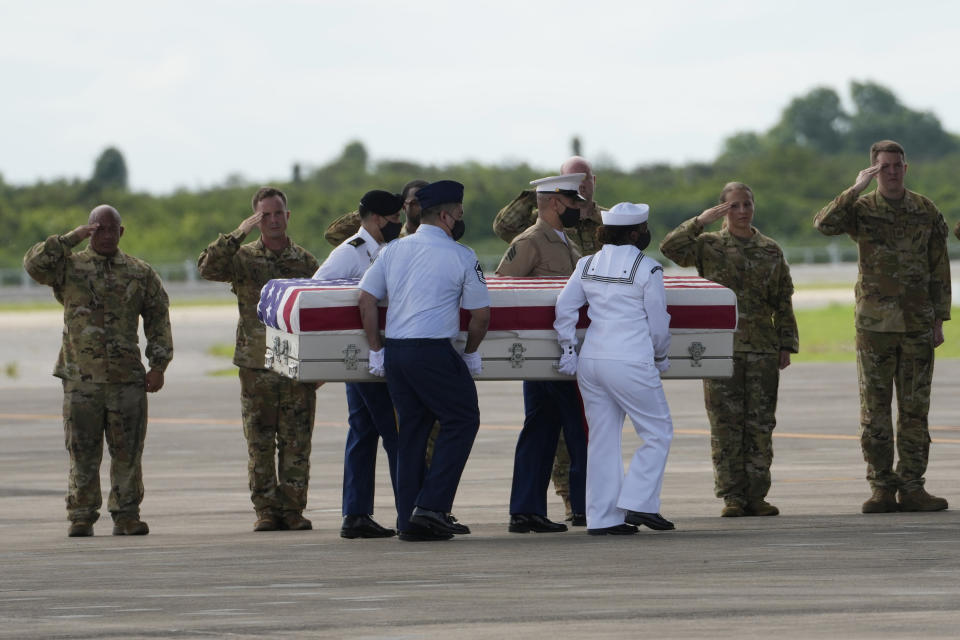 U.S. military salute the possible remains of a WWII U.S. airman found in northern Thailand to a waiting C-17 during a repatriation ceremony Wednesday, May 18, 2022, at the U-Tapao Air Base in Rayong province, eastern Thailand. The possible human remains were found at a crash site in a rice field in northern Thailand by the Defense POW/MIA Accounting Agency and were sent to Hawaii where they will be tested to see if they belong to a U.S. pilot who went missing in 1944. (AP Photo/Sakchai Lalit)