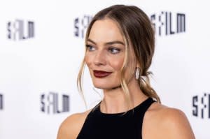 Margot Robbie Reveals She Improvised a 'Babylon' Scene to Kiss Brad Pitt: ‘Sue Me’ black dress