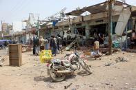 <p>Yemenis gather next to the destroyed bus at the site of a Saudi-led coalition air strike, that targeted the Dahyan market the previous day in the Huthi rebels’ stronghold province of Saada on Aug. 10, 2018. (Photo: Stringer/AFP/Getty Images) </p>