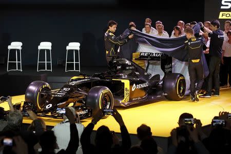 Renault Formula One racing driver Kevin Magnussen of Denmark (2ndR) and teammate Jolyon Palmer of Britain (L) unveil the new Renault RS16 car during its official presentation at the company's research center, the Technocentre, in Guyancourt, near Paris, France, February 3, 2016. REUTERS/Benoit Tessier