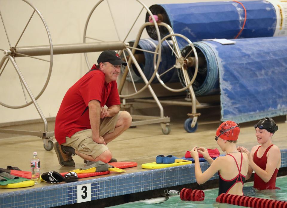 Poulsbo Piranhas Swim Team coach Ron Allen looks on from the pool deck as his team gets started during practice at the NK Community Pool on Wednesday, July 12, 2023.