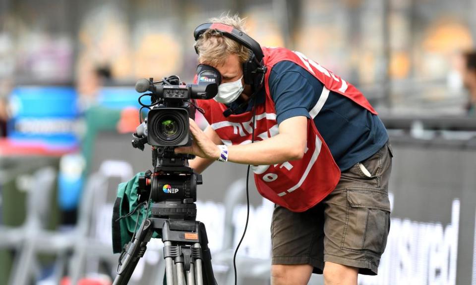 A Foxtel cameraman films an AFL match