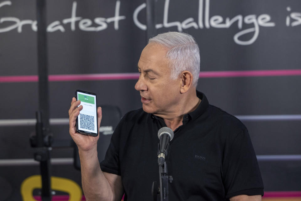 Israeli Prime Minister Benjamin Netanyahu talks to the media during a visit to the Fitness gym ahead of the re-opening of the branch in Petah Tikva, Israel, on Saturday, Feb. 20, 2021. (AP Photo/Tal Shahar, Yediot Ahronot, Pool)