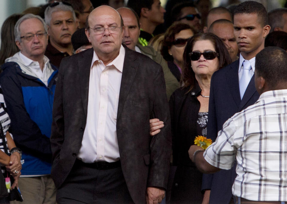 The parents of Monica Spear, Rafael Spear and Edna Mootz de Spear, attend their daughter's funeral at the East Cemetery in Caracas, Venezuela, Friday, Jan. 10, 2014. Robbers killed Spear, a former Miss Venezuela, and her former husband Thomas Henry Berry, late Monday night on an isolated stretch of highway while the couple was returning to the capital by car with their 5-year-old daughter from a vacation. (AP Photo/Alejandro Cegarra)