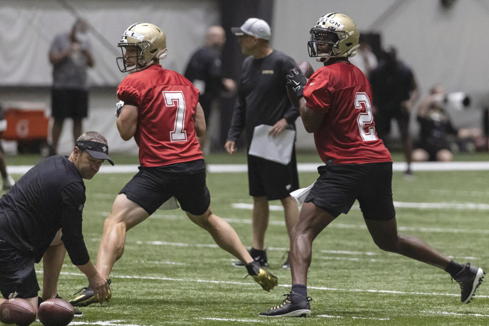 New Orleans Saints quarterbacks quarterback Taysom Hill (7) and Jameis Winston (2) run drills during NFL football training camp in Metairie, Thursday, July 29, 2021. (AP Photo/Derick Hingle)