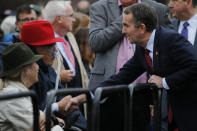 Virginia Gov. Ralph Northam, right, greets Pam Royall and Bill Royall, left, prior to the unveiling ceremony for a statue titled Rumor's of War by artist Kehinde Wiley at the Virginia Museum of Dine Arts in Richmond, Va., Tuesday, Dec. 10, 2019. The monumental bronze sculpture of a young black man astride a galloping horse was unveiled Tuesday, set to be permanently installed in Virginia's capital city, not far from the Confederate monument it mimics. (AP Photo/Steve Helber)