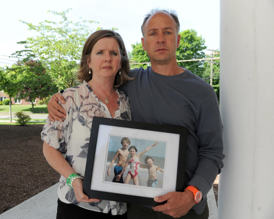 Mark Barden and his wife, Jackie, hold a photo of their children. (Photo: New York Daily News via Getty Images)