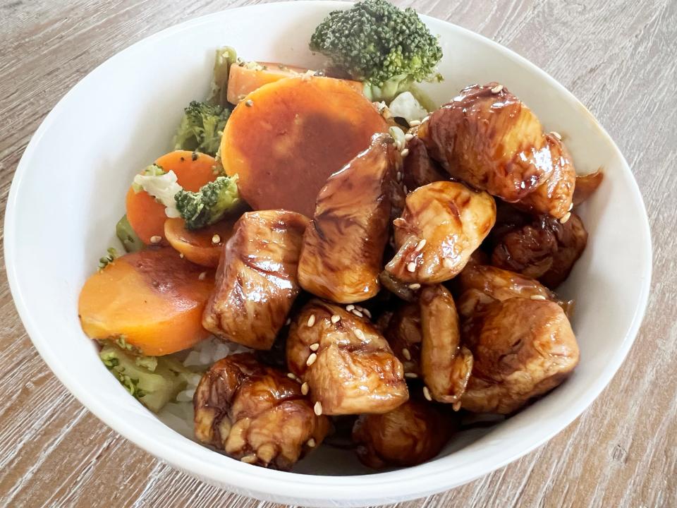 Teriyaki chicken in white bowl with vegetables and rice