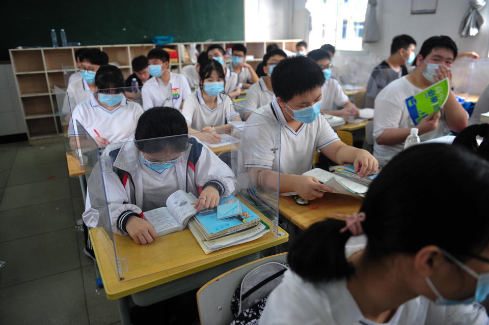 Students read books in the classroom at a high school in Wuhan in central China's Hubei province on July 10, the first day for 10th and 11th grade students to resume school.