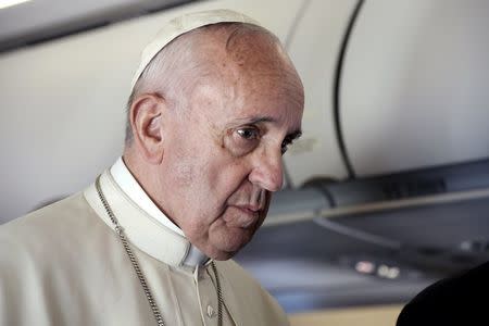 Pope Francis speaks to journalists on his flight back to Rome following a visit at the Moria refugee camp in the Greek island of Lesbos, April 16, 2016. REUTERS/ Filippo Monteforte/Pool