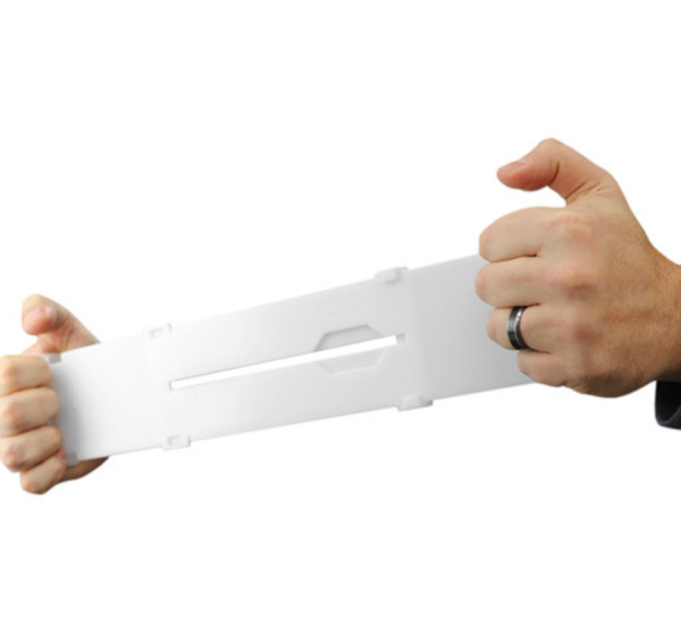 White Adjustable Drawer Organisers from Temple & Webster. Hands are holding one divider.