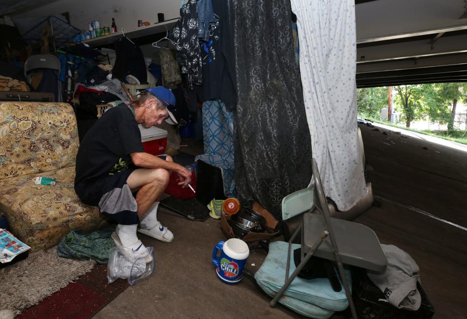 Brent Spradlin sits next to his makeshift tent in a homeless camp beneath the I-65 overpass at Brook and Breckinridge streets. Spradlin was stressed about moving from the camp after the city announced it would clear it. July 8, 2019