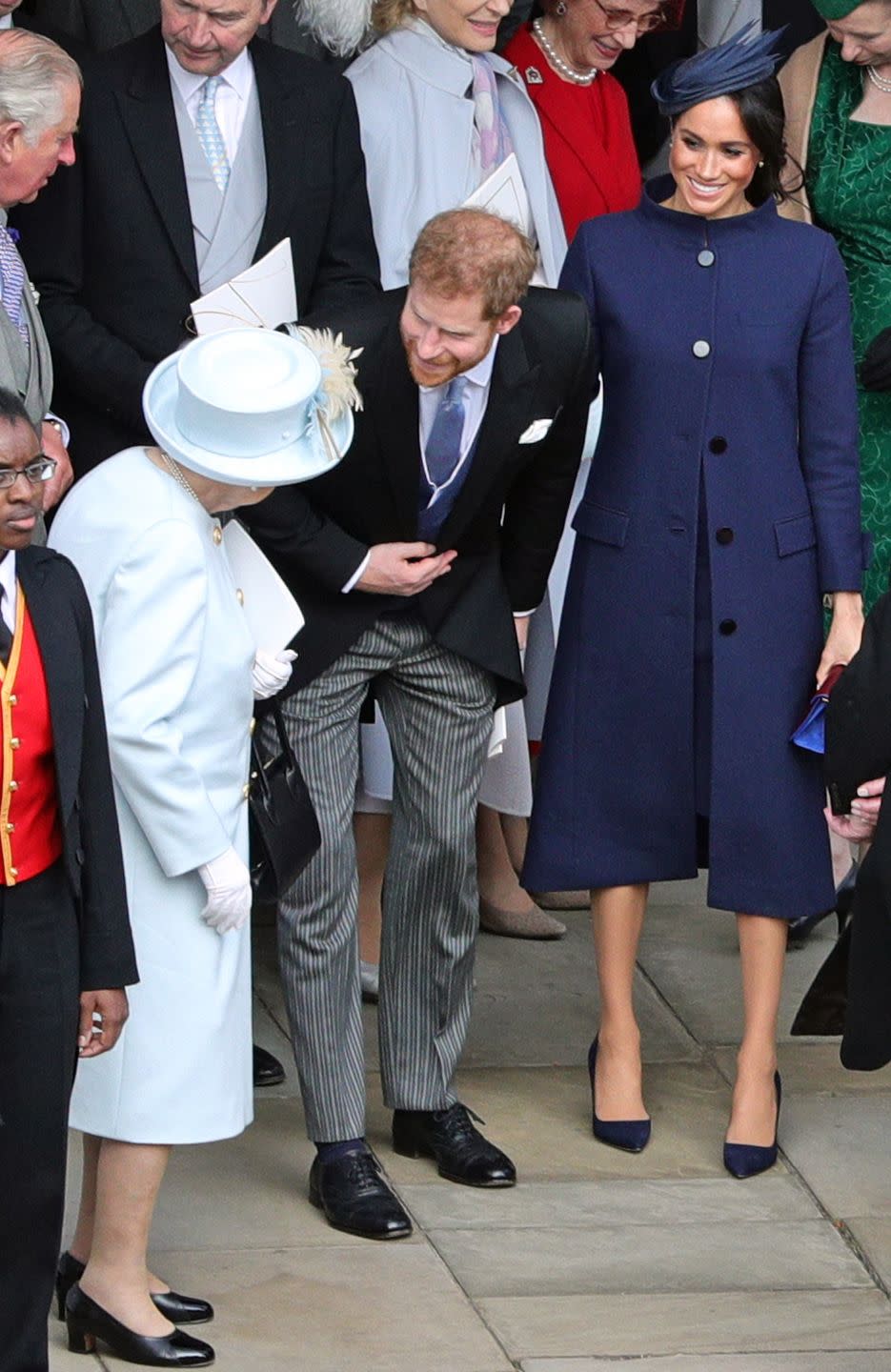 Prince Harry and Meghan Markle talk to the Queen following Princess Eugenie and Jack Brooksbank's wedding.