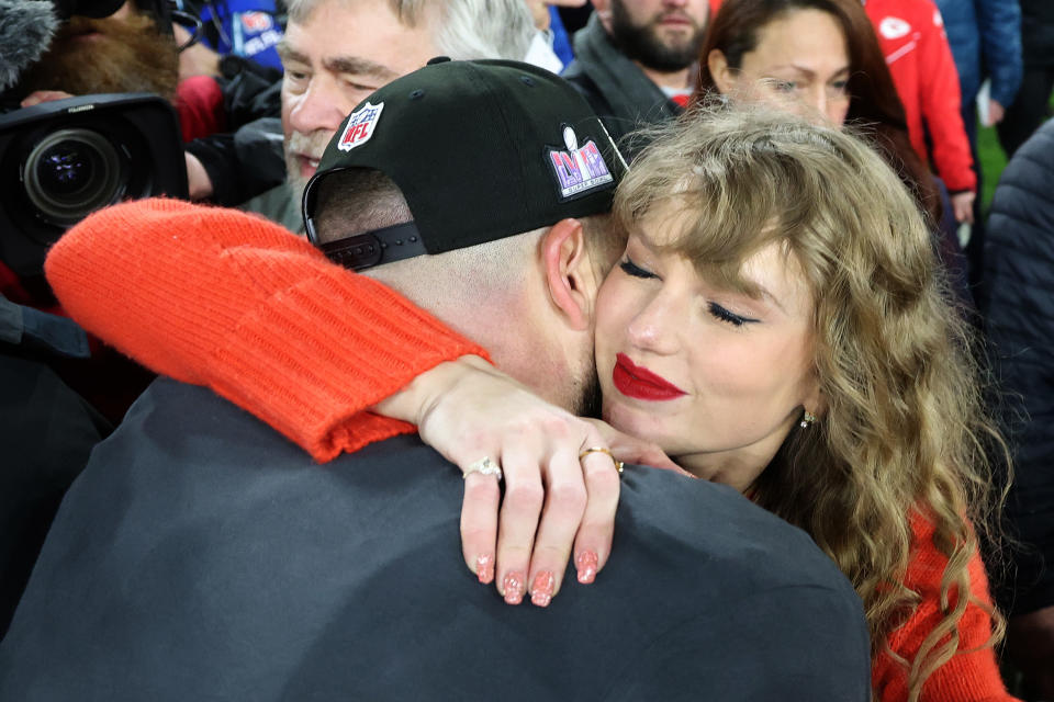 Travis Kelce #87 of the Kansas City Chiefs celebrates with Taylor Swift after a 17-10 victory against the Baltimore Ravens in the AFC Championship Game.