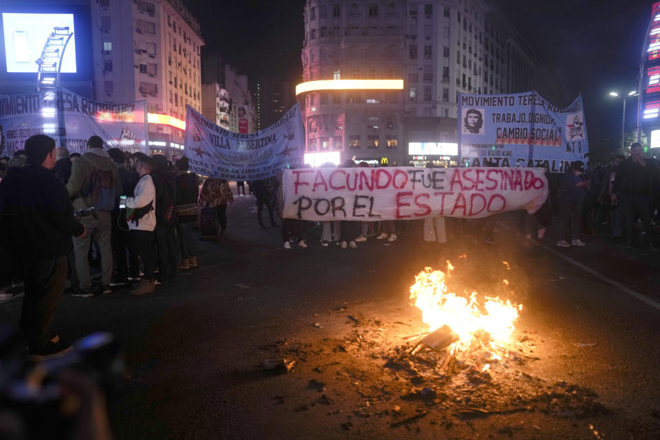 Demonstrators hold a banner reading in Spanish "Facundo was killed by the state" during a protest in Buenos Aires, Argentina, Thursday, Aug. 10, 2023. The original protest which had been called by several left-wing groups, intensified after police tried to disperse it and a man died of a heart attack while the police were detaining him. (AP Photo/Natacha Pisarenko)