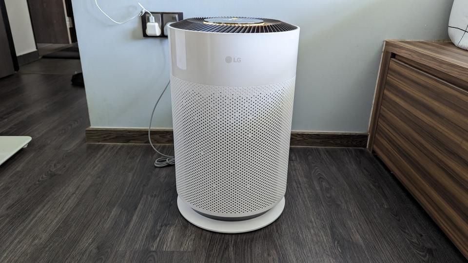 The LG PuriCare 360˚ HIT Air Purifier unit on a wooden floor.
