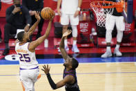 Phoenix Suns' Mikal Bridges, left, goes up for a shot against Philadelphia 76ers' Shake Milton during the second half of an NBA basketball game, Wednesday, April 21, 2021, in Philadelphia. (AP Photo/Matt Slocum)