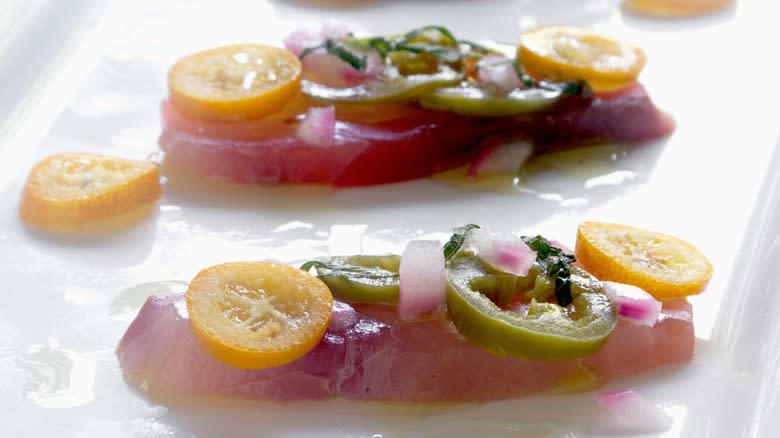 Close-up of two pieces of prepared crudo on a plate