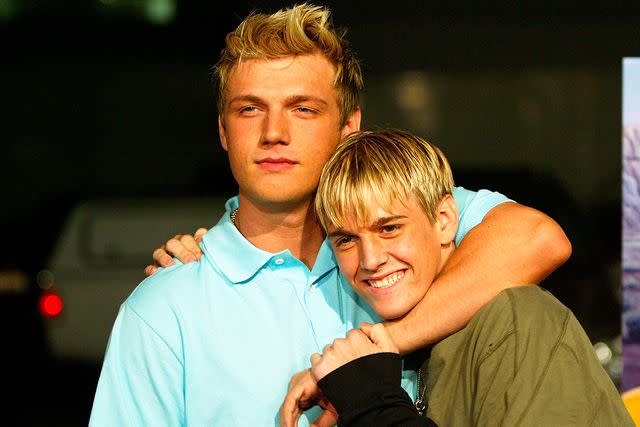 <p>Frazer Harrison/Getty</p> Nick Carter and his brother Aaron Carter arrive for the 'Simple Life 2' Welcome Home Party at The Spider Club in April 2004 in Hollywood, California