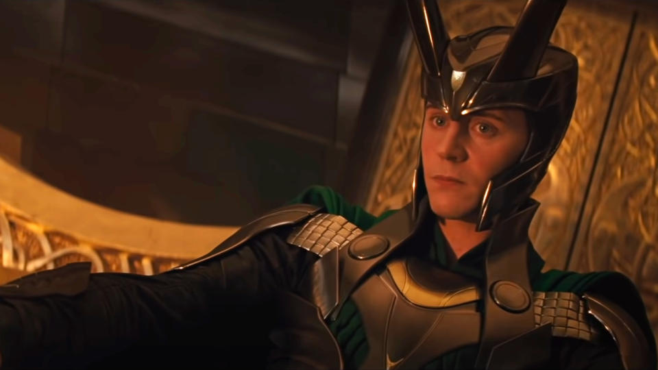 Tom Hiddleston sits seriously on the throne of Asgard in Thor.