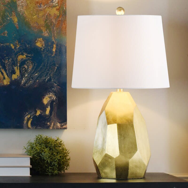 This lamp has been hand-painted gold, giving it a distressed look that'll be cool on any desk. It is LED-compatible and has a polarized plug and a three-way switch. The lamp doesn't come with a bulb, so you'll have to get an <a href="https://amzn.to/3kiHd0q" target="_blank" rel="noopener noreferrer">E26 bulb</a>. <a href="https://fave.co/3molNke" target="_blank" rel="noopener noreferrer">Find it for $77 at Wayfair</a>.