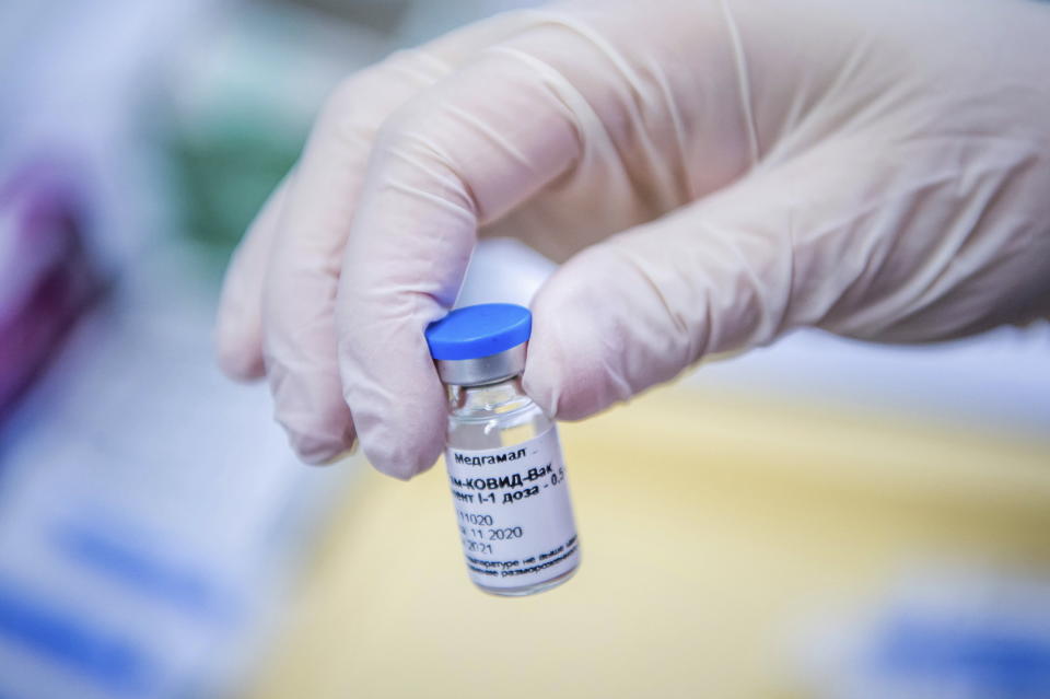 A vial containing Russian vaccine Sputnik V is shown by a nurse at the South Pest Central Hospital in Budapest, Hungary, Friday, Feb. 12, 2021, as the vaccination with Sputnik V against the new coronavirus begins in the country. (Zoltan Balogh/MTI via AP)