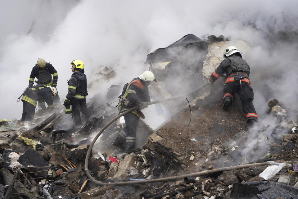 Rescuers work at the scene of a building damaged by Russian rocket attack in Kharkiv, Ukraine, Tuesday, Jan. 23, 2024. (AP Photo/Andrii Marienko)