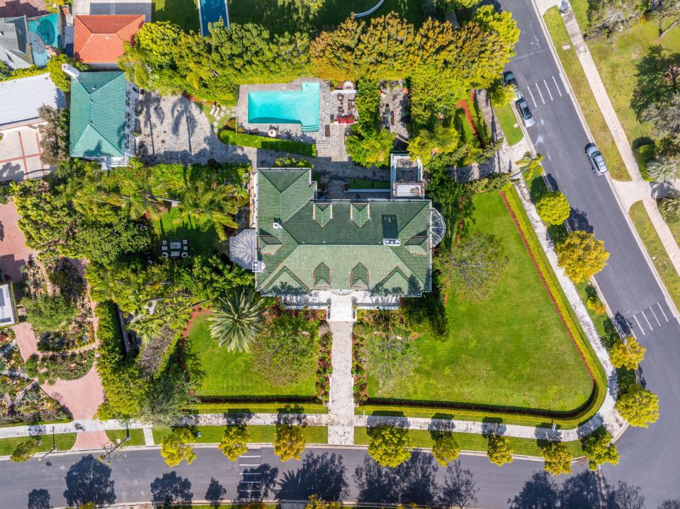 This mansion in a gated part of Fremont Place, within Hancock Park, Los Angeles, used to belong to boxing champion Muhammad Ali. It is up for auction, listed at $13.5 million.