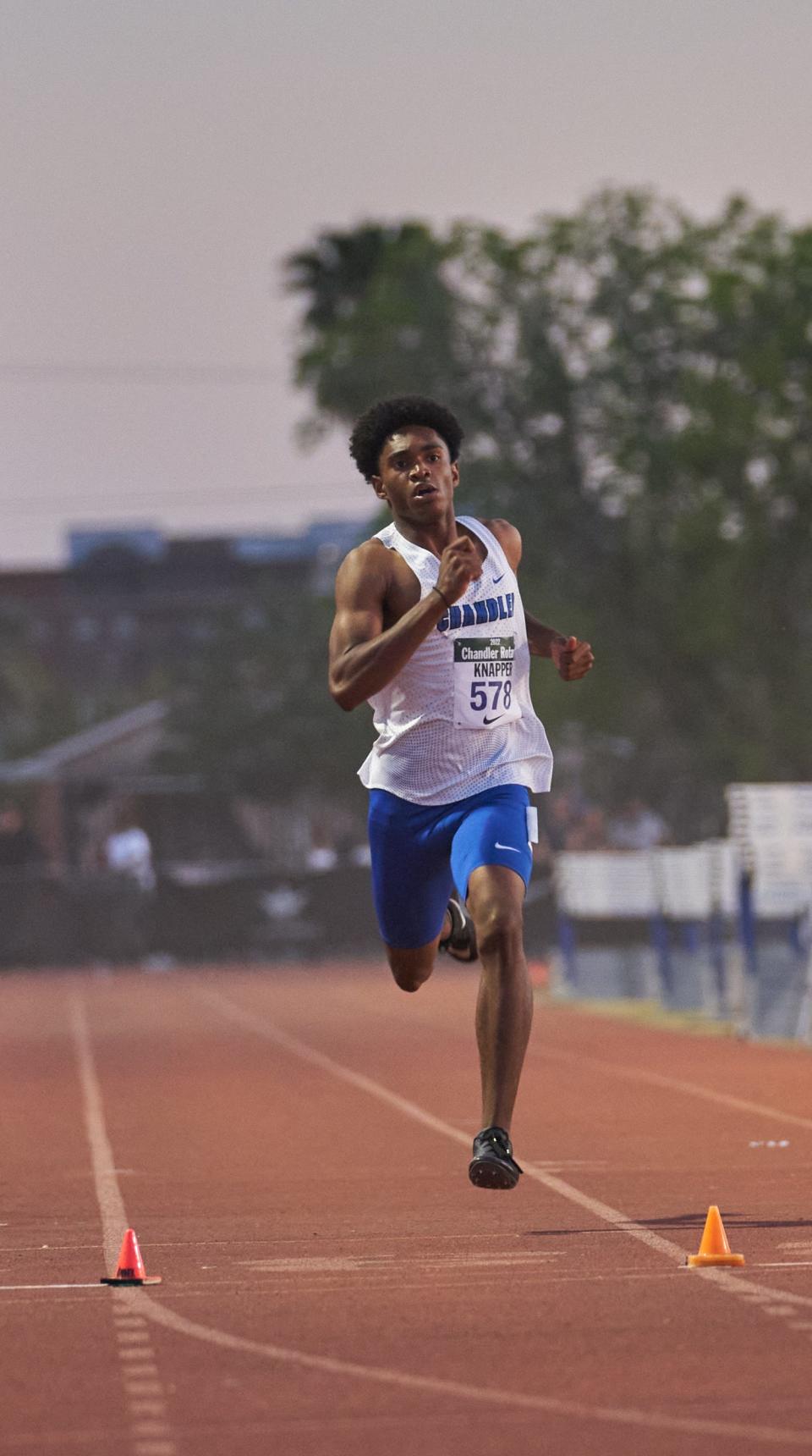 Mar 26, 2022; Chandler, Arizona, USA; Otis Knapper of Chandler crosses the line in the second heat of the Boys 400 Meter Dash during the Chandler Rotary Track Meet at Chandler High School Austin Field track. Mandatory Credit: Alex Gould-Arizona Republic