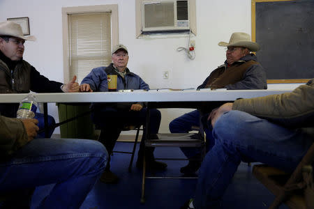Volunteers and ranchers sit at a table to talk about the aftermath of the Perryton fire in Lipscomb, Texas, U.S., March 12, 2017. REUTERS/Lucas Jackson